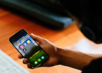 A high school student poses with his mobile phone showing his social media applications in Melbourne, Australia, November 28, 2024. REUTERS/Asanka Brendon Ratnayake