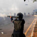 A policeman fires rubber bullets to disperse PTI supporters in Islamabad on November 26, 2024. — AFP