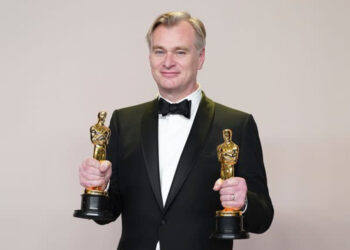 Christopher Nolan celebrating his two wins at the Oscars earlier this year ( Associated Press)