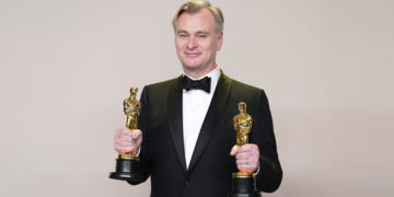 Christopher Nolan celebrating his two wins at the Oscars earlier this year ( Associated Press)