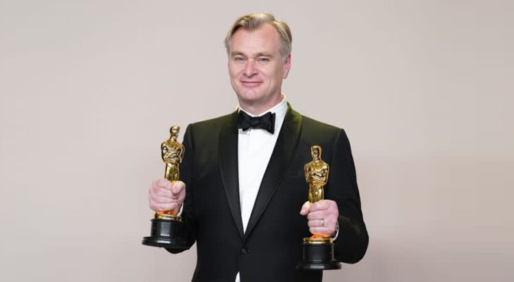 Christopher Nolan celebrating his two wins at the Oscars earlier this year ( Associated Press)