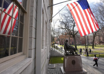 People walk past the John Harvard statue in Harvard Yard, Tuesday, Dec. 17, 2024, on the campus of Harvard University in Cambridge, Mass. (AP Photo/Steven Senne)