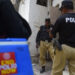 Policemen escort a polio vaccination team during a door-to-door campaign in June (Getty Images)