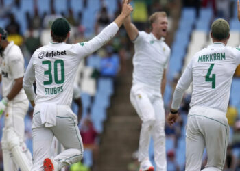 South Africa's players celebrate after teammate Corbin Bosch took a wicket during third International cricket match between South Africa and Pakistan, at the Wanderers stadium in Johannesburg, South Africa, Thursday, Dec. 26, 2024. (AP Photo/Themba Hadebe)ASSOCIATED PRESS