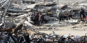 FILE/ Palestinians stand among the rubble of houses destroyed in previous Israeli strikes, amid ceasefire negotiations with Israel, in Gaza City, January 15, 2025. REUTERS/Mahmoud Issa