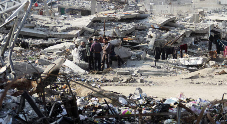 FILE/ Palestinians stand among the rubble of houses destroyed in previous Israeli strikes, amid ceasefire negotiations with Israel, in Gaza City, January 15, 2025. REUTERS/Mahmoud Issa