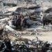 Palestinians stand among the rubble of houses destroyed in previous Israeli strikes, amid ceasefire negotiations with Israel, in Gaza City, January 15, 2025. REUTERS/Mahmoud Issa