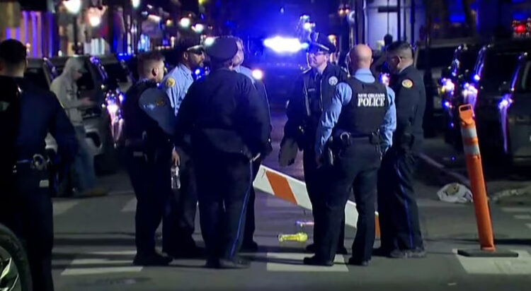 Police officers stand at the scene where a truck drove into a large crowd on Bourbon Street in the French Quarter of New Orleans, Louisiana, U.S. January 1, 2025 in this screengrab taken from a video. ABC Affiliate WGNO/Handout via REUTERS