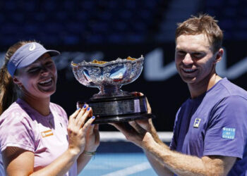 Olivia Gadecki and John Peers pose with the trophy after winning the mixed doubles final (REUTERS)