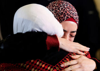 Palestinians react during the arrival of buses carrying Palestinians who were released from Israeli jails. Follow the latest developments, live. Photograph: Mussa Qawasma/Reuters