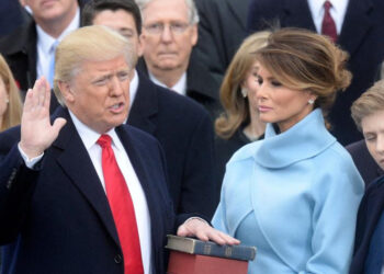 Donald Trump is pictured taking the presidential oath in 2017 as his wife Melania Trump holds the Bible. (Alamy)