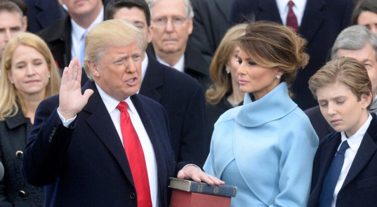 Donald Trump is pictured taking the presidential oath in 2017 as his wife Melania Trump holds the Bible. (Alamy)