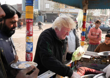 Saleem Bagga, seen by some as a lookalike of U.S. President-elect Donald Trump, sells kheer, a traditional South Asian rice pudding, along a road in Sahiwal, Pakistan January 13, 2025. REUTERS/Nida Meboob