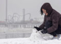 Paige Encarnacion builds a snowman on the beach during a winter storm on Tuesday, Jan. 21, 2025 in Galveston, Texas. (Brett Coomer/Houston Chronicle via AP)