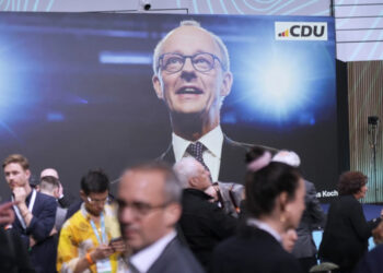 Supporters of Friedrich Merz, the candidate of the mainstream conservative Christian Democratic Union party wait for the closing of polling stations and the announcement of the first projections at the party headquarters in Berlin, Germany, Sunday, Feb. 23, 2025, after the German national election. (AP Photo/Markus Schreiber)