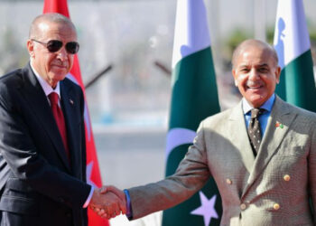 Turkey's President Recep Tayyip Erdogan shaking hands with Pakistan's Prime Minister Shehbaz Sharif before inspecting a guard of honour during his ceremonial reception at the Prime Minister House in Islamabad [Pakistan's Prime Minister Office / AFP]