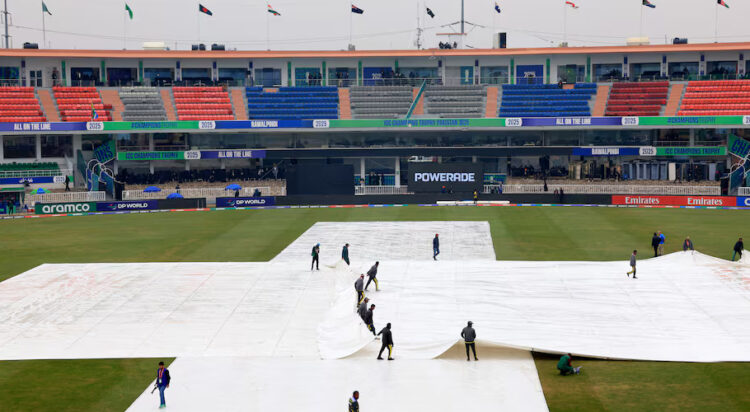 Cricket - ICC Men's Champions Trophy - Group B - Australia v South Africa - Rawalpindi Cricket Stadium, Rawalpindi, Pakistan - February 25, 2025 Groundstaff pull rain covers on the pitch before the match REUTERS/Akhtar Soomro