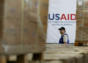 A man walks past boxes of USAID humanitarian aid at a warehouse in Colombia in 2019.Fernando Vergara / AP file