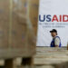 A man walks past boxes of USAID humanitarian aid at a warehouse in Colombia in 2019.Fernando Vergara / AP file