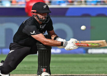 New Zealand’s Daryl Mitchell plays a shot during the ICC Champions Trophy one-day international (ODI) final cricket match between India and New Zealand at the Dubai International Stadium in Dubai on March 9, 2025. (Photo by FADEL SENNA / AFP)