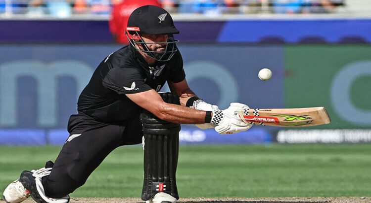 New Zealand’s Daryl Mitchell plays a shot during the ICC Champions Trophy one-day international (ODI) final cricket match between India and New Zealand at the Dubai International Stadium in Dubai on March 9, 2025. (Photo by FADEL SENNA / AFP)