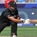 New Zealand’s Daryl Mitchell plays a shot during the ICC Champions Trophy one-day international (ODI) final cricket match between India and New Zealand at the Dubai International Stadium in Dubai on March 9, 2025. (Photo by FADEL SENNA / AFP)