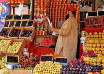 Vendor cleaning his fruits on a stall: File photo