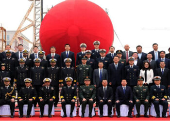 Pakistan’s Vice Chief of the Naval Staff Vice Admiral Ovais Ahmed Bilgrami gestures for a group photography with officials from Pakistan Navy and China Shipyard during the launching ceremony of second HANGOR Class Submarine at Wuhan, China. March 15, 2025 (Handout/Pakistan Navy)