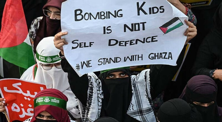 Supporters of the Jamaat-i-Islaami (JI) party hold a poster as they gather in solidarity with Palestinians during a protest in Islamabad on April 20. — AFP