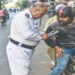 A motorcyclist is caught by a sergeant over wrong-way violation. —Fahim Siddiqi / White Star via Dawn.com