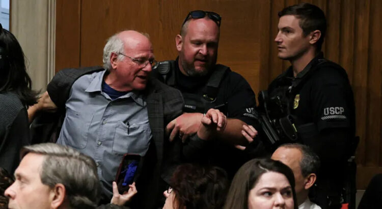 According to NBC News, Cohen was one of seven protesters forcibly removed from the hearing and charged with the misdemeanor offense of Crowding (Reuters)