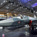 Visitors stand next to a prototype of the Advanced Medium Combat Aircraft (AMCA), India's most advanced stealth fighter jet, at the "Aero India 2025" air show at Yelahanka air base in Bengaluru, India, February 11, 2025. REUTERS/Stringer/File Photo