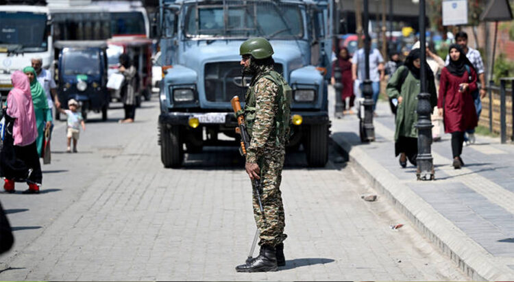 An Indian paramilitary soldier stands guard along a street in Srinagar on May 14, 2025. (AFP/File)