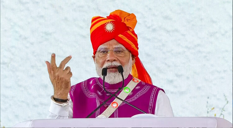 Prime Minister Narendra Modi addresses the gathering during the foundation stone laying and inauguration ceremony of multiple development projects in Dahod on Monday. (ANI)