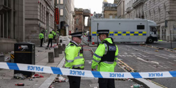 Police officers work at the scene after an incident where a car plowed into a crowd of Liverpool fans during a parade celebrating their side's Premier League soccer title, in central Liverpool, Britain, May 27, 2025. REUTERS/Phil Noble
