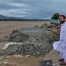 Local residents at the Swat River, which is overflowing due to pre-monsoon heavy rains in the area on the outskirts of Mingora, the main town of Pakistan's Swat Valley [Sherin Zada/AP]