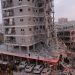 People stand near a residential building that was hit following missile attack from Iran on Israel, at central Israel June 15, 2025. REUTERS/Tomer Appelbaum