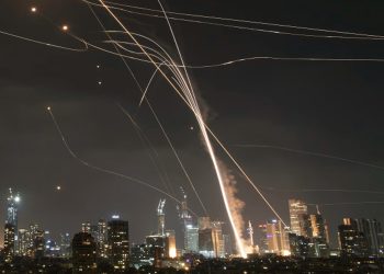A projectile hit buildings in Tel Aviv as Israel’s Iron Dome air-defense system fired to intercept missiles on Friday. Photo: Leo Correa/Associated Press