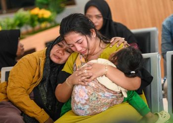 Relatives waiting for updates on search efforts for at least 38 people still missing after a boat sank off Bali island. (AFP)