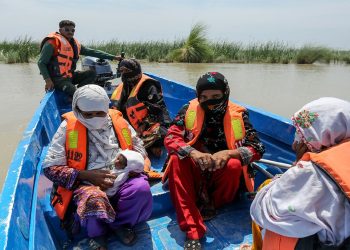 Rescue personnel evacuate villagers by boat from a flooded village following heavy rains in the Taunsa district of Punjab on July 16, 2025. — AFP