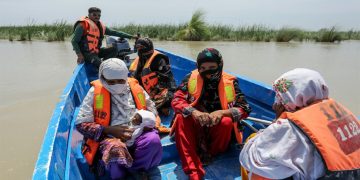 Rescue personnel evacuate villagers by boat from a flooded village following heavy rains in the Taunsa district of Punjab on July 16, 2025. — AFP
