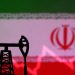 Iranian flag with stock graph and an oil pump jack miniature model are seen in this illustration taken October 9, 2023. REUTERS/Dado Ruvic/Illustration/File Photo
