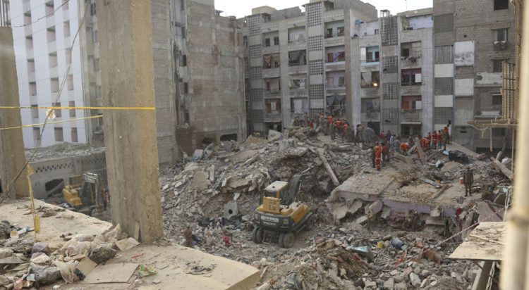 Pakistani troops, rescue workers and volunteers look for survivors amid the rubble of a collapsed building in Karachi, Pakistan, June 8, 2020. (File/AP Photo)