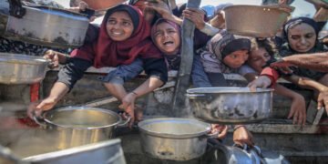 People wait to receive hot meals in Gaza this month. Photograph: Anadolu/Getty Images