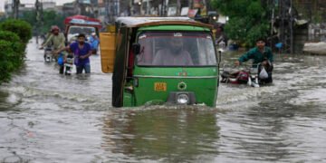Motorists drive through a flooded road caused by heavy monsoon rain in Lahore, Pakistan, on July 23, 2025. (AP Photo/File)