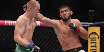 Islam Makhachev (red gloves) fights against Iah Machado Garry (blue gloves) in the welterweight title bout during UFC 330 at Xfinity Mobile Arena on August 16, 2026. — Reuters